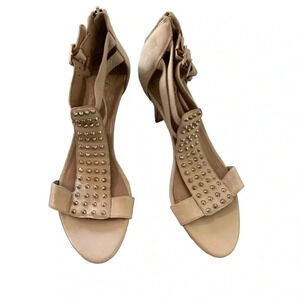 VINCE Camuto Conical studs march down the T-strap of an edgy sandal set